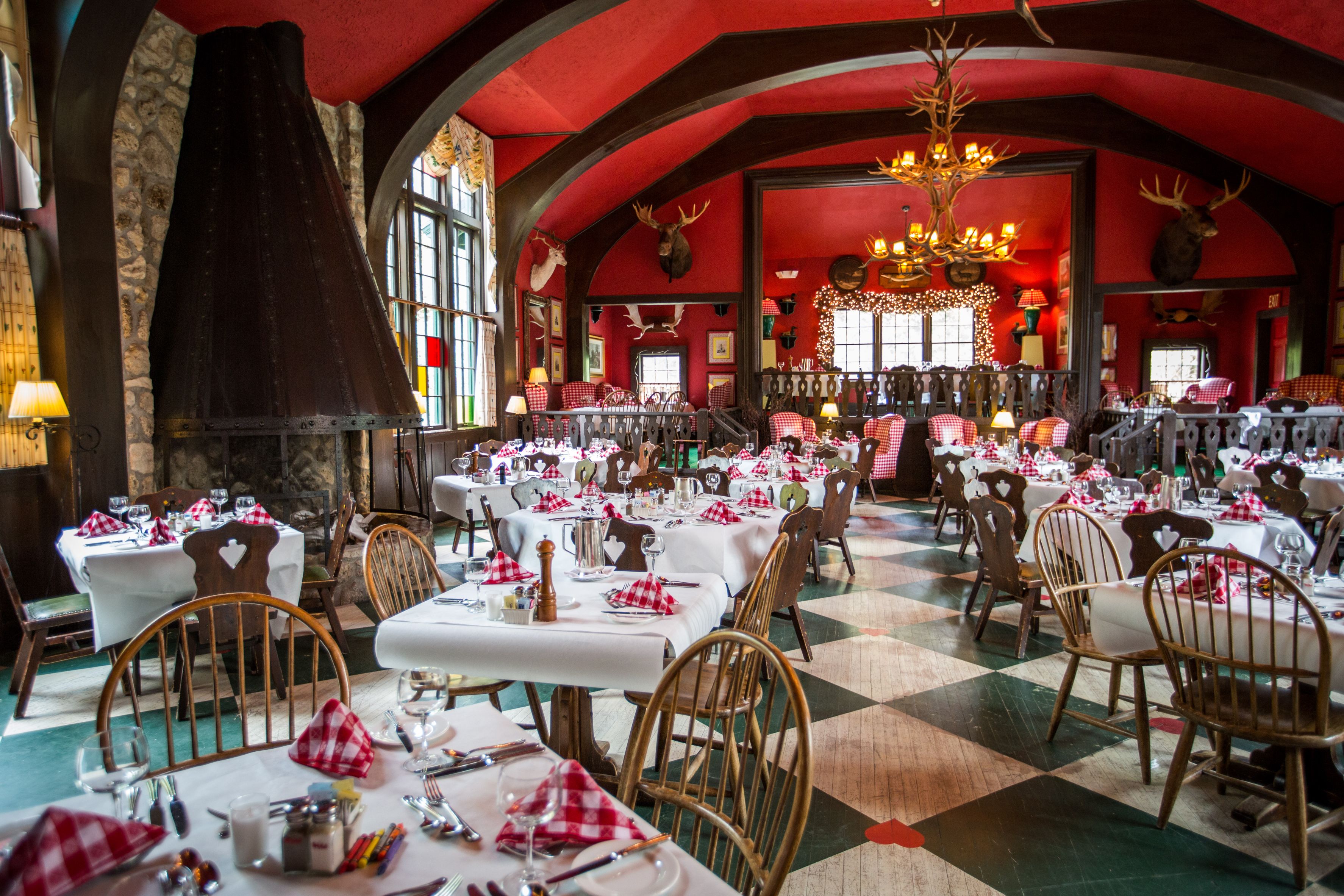 Image of Wood’s Restaurant with checkered flooring, and bright cherry walls for a fun dining experience. Grand Hotel, a member of Historic Hotels since 2001, dates to 1886. It is located in Mackinac Island, Michigan.